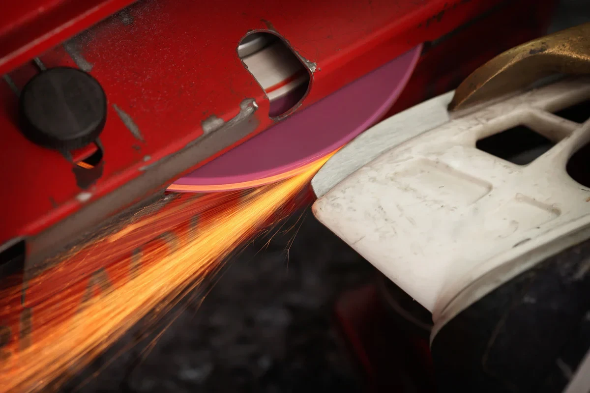A very cinematic image of sharpening skates, sparks flying.
